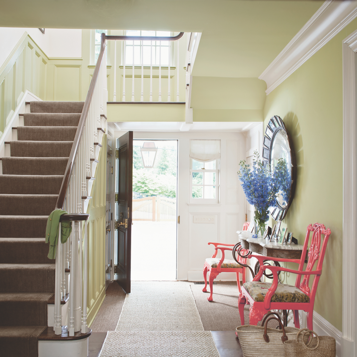 A hallway painted light green with Benjamin Moore Aura interior eggshell wall paint.