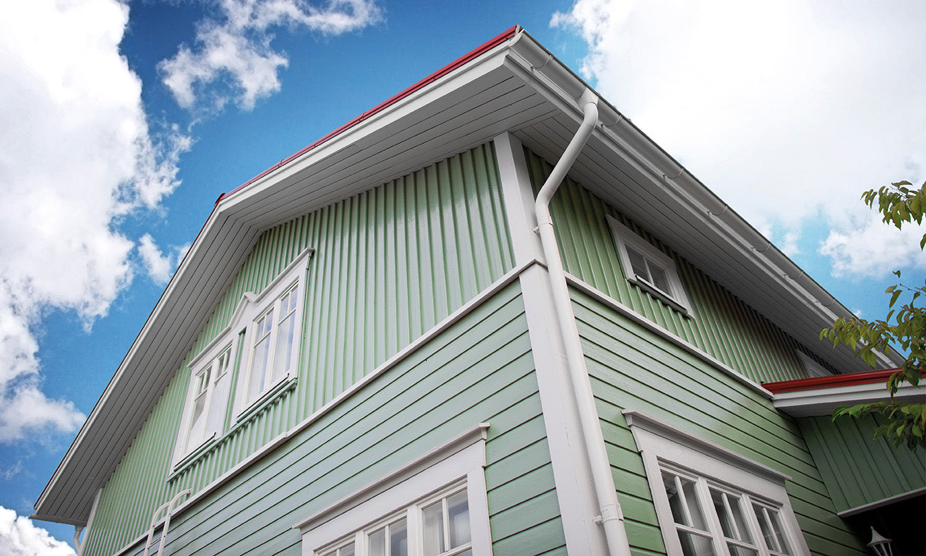 A wooden cladding house painted green in Teknos Nordica Wood Paint